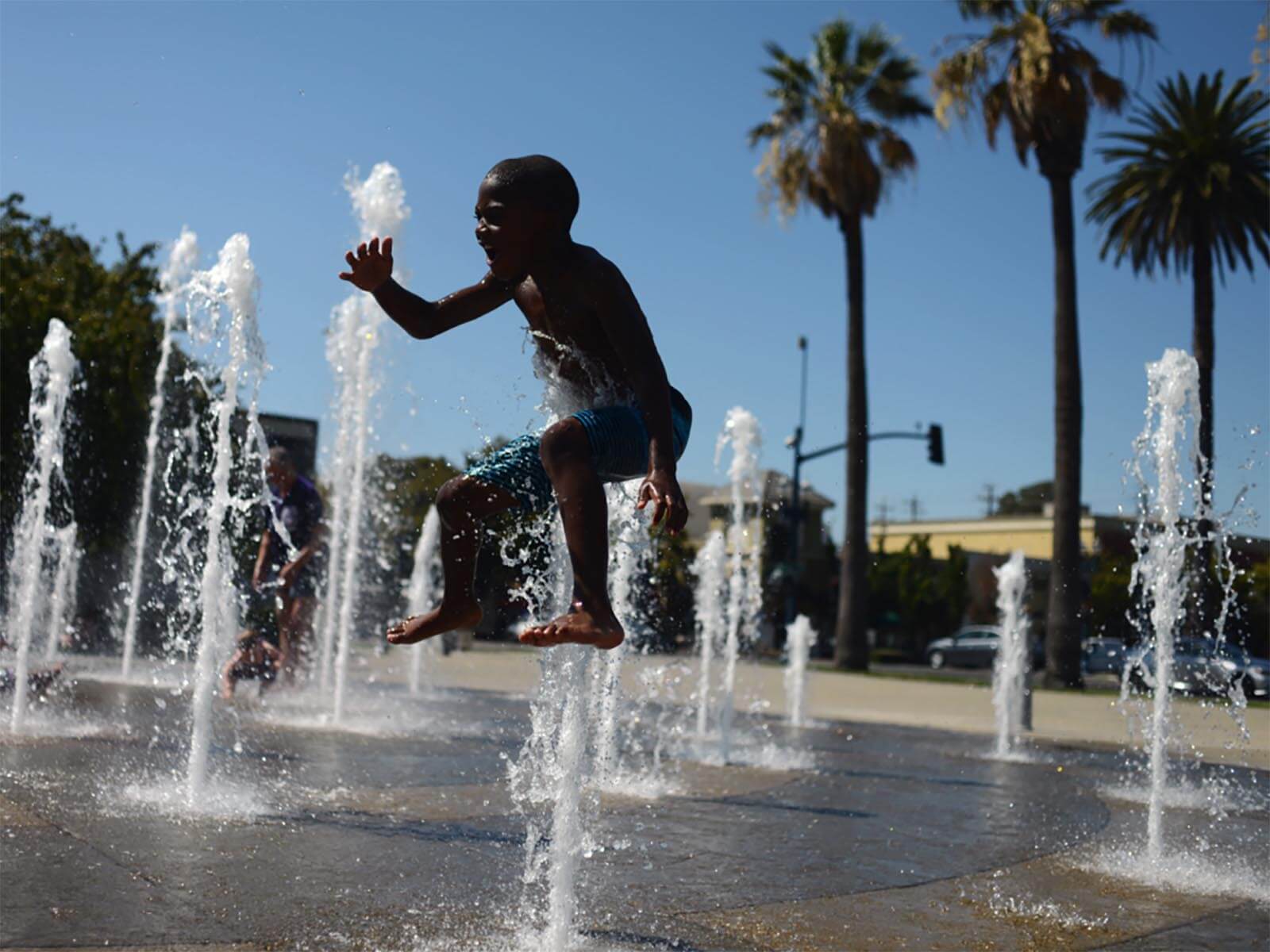 Child playing in public water fountain in Fairfield CA
