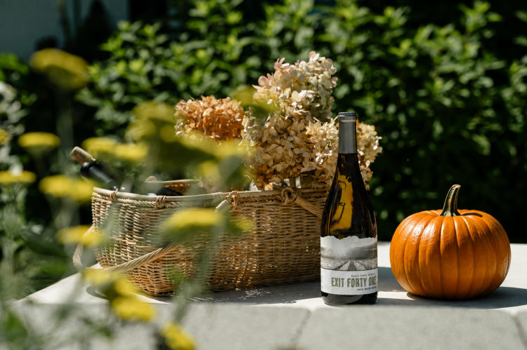 Wine bottle, pumpkin, picnic basket.